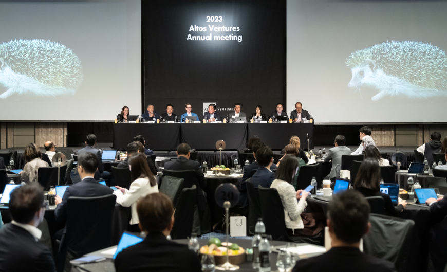 Panel and audience at Altos Ventures’ 2023 annual meeting, with hedgehogs on the presentation screens