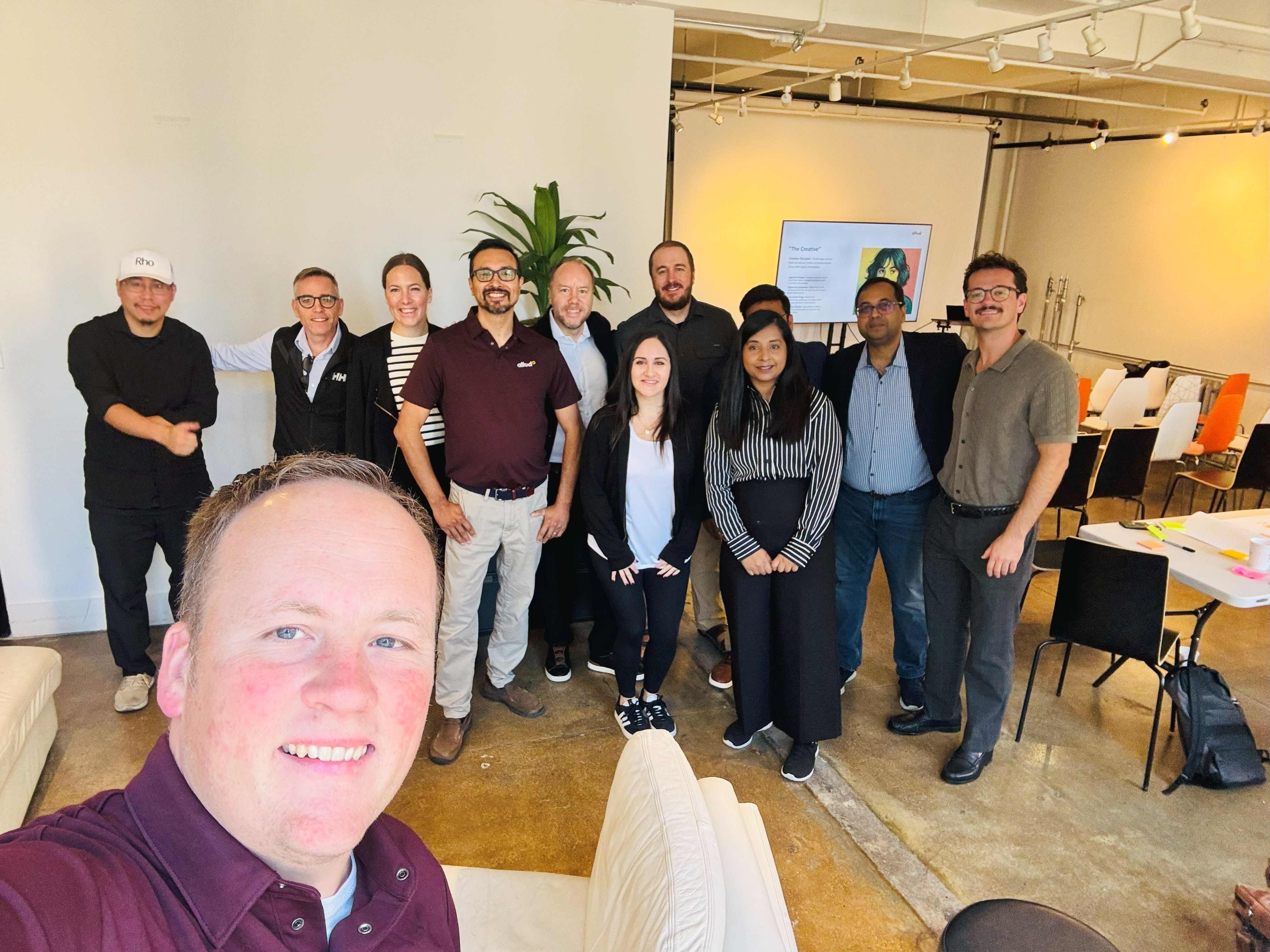 Altudo colleagues posing together in a meeting and workshop space