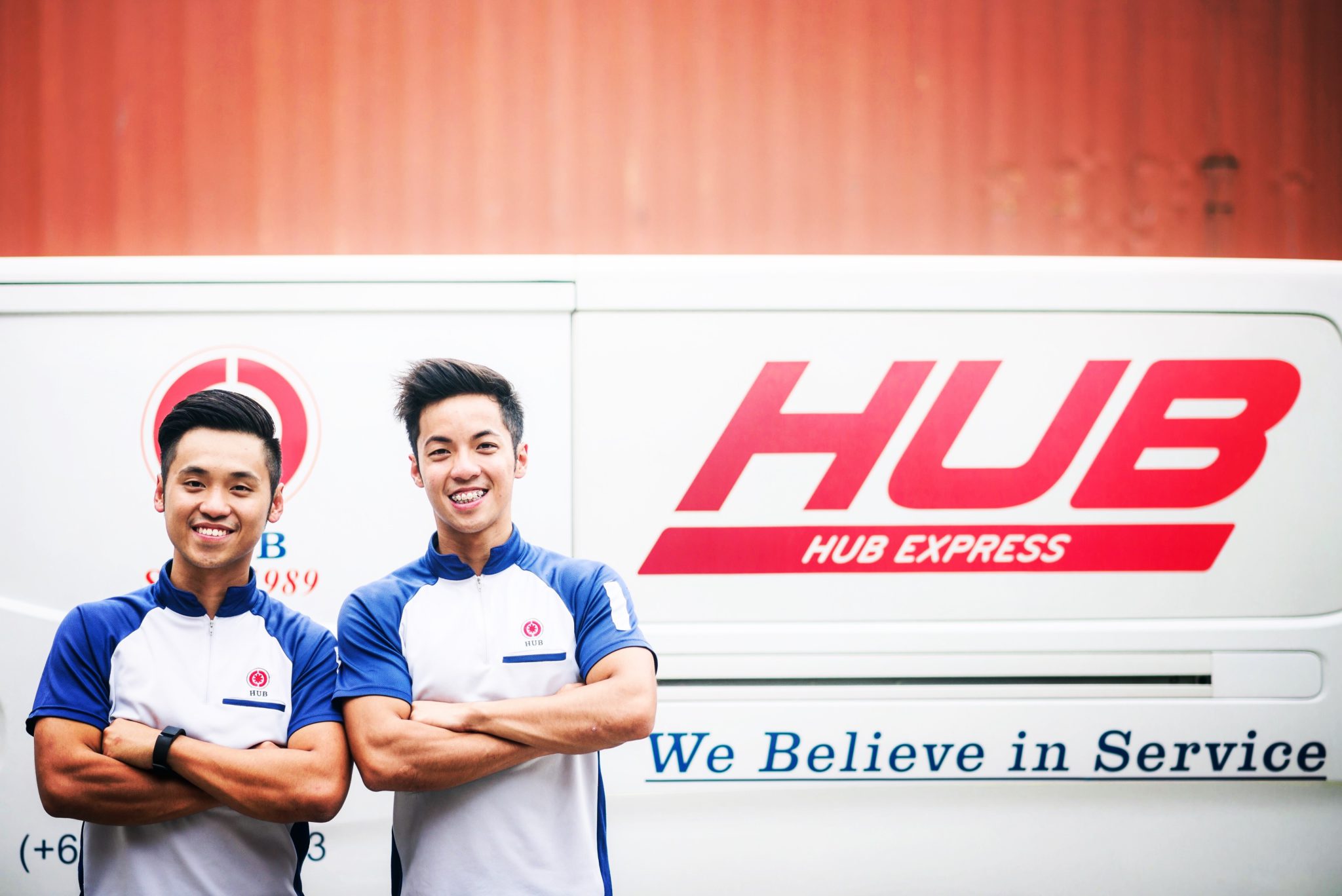 Alvin Ea, left, and his brother Andy standing beside a Hub Express van in 2015