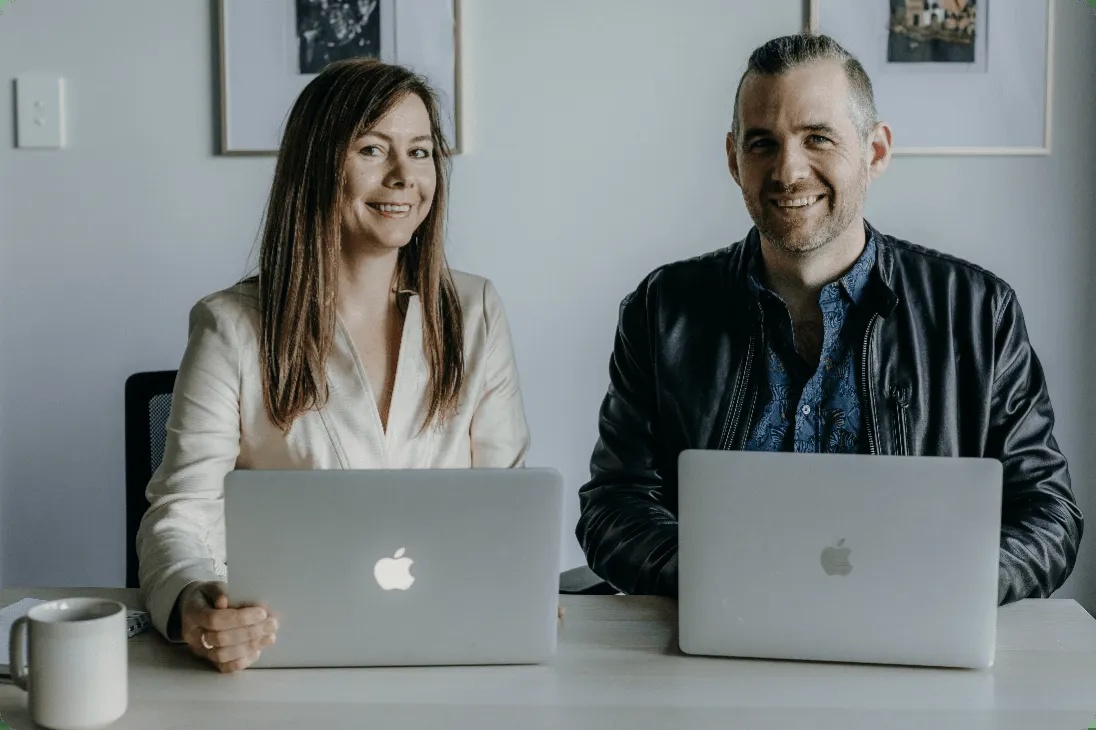 Alyona Medelyan and Nathan Holmberg seated together behind their laptops