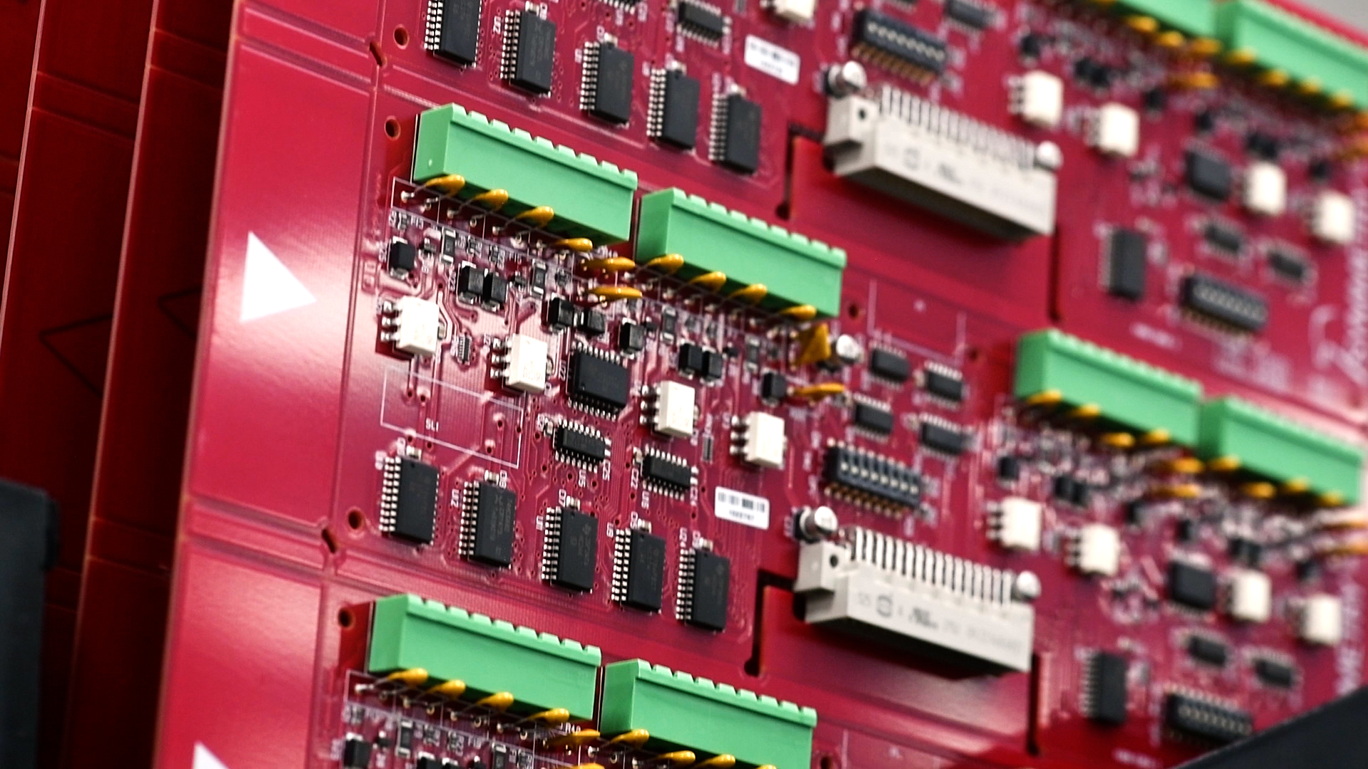 Close-up of red AMAG access-control circuit boards with green terminal connectors