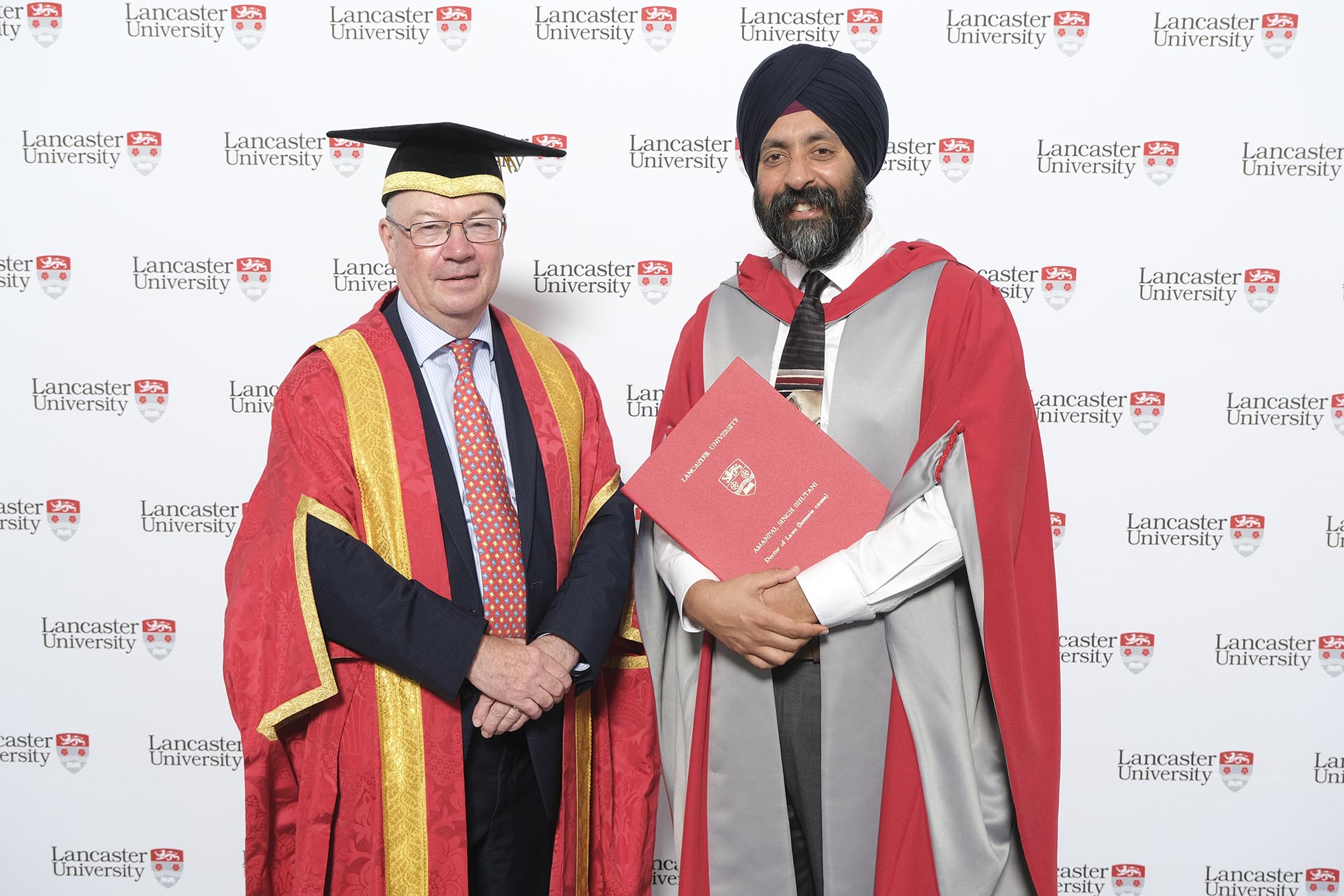 Aman Bhutani, right, with Lancaster University Pro-Chancellor Alistair Burt at his honorary degree ceremony