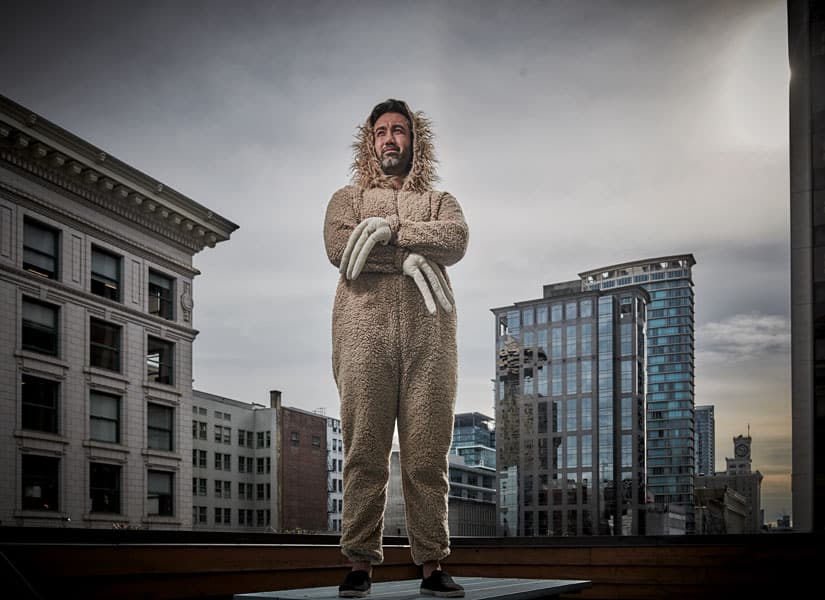 Aman Mann wearing a sloth costume on a Vancouver rooftop