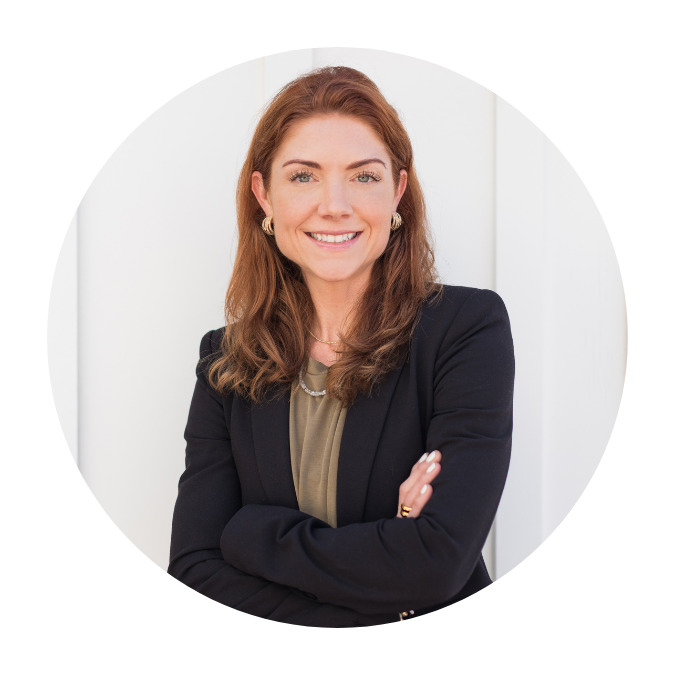 Amanda Christoff in a black blazer and olive blouse against a neutral background