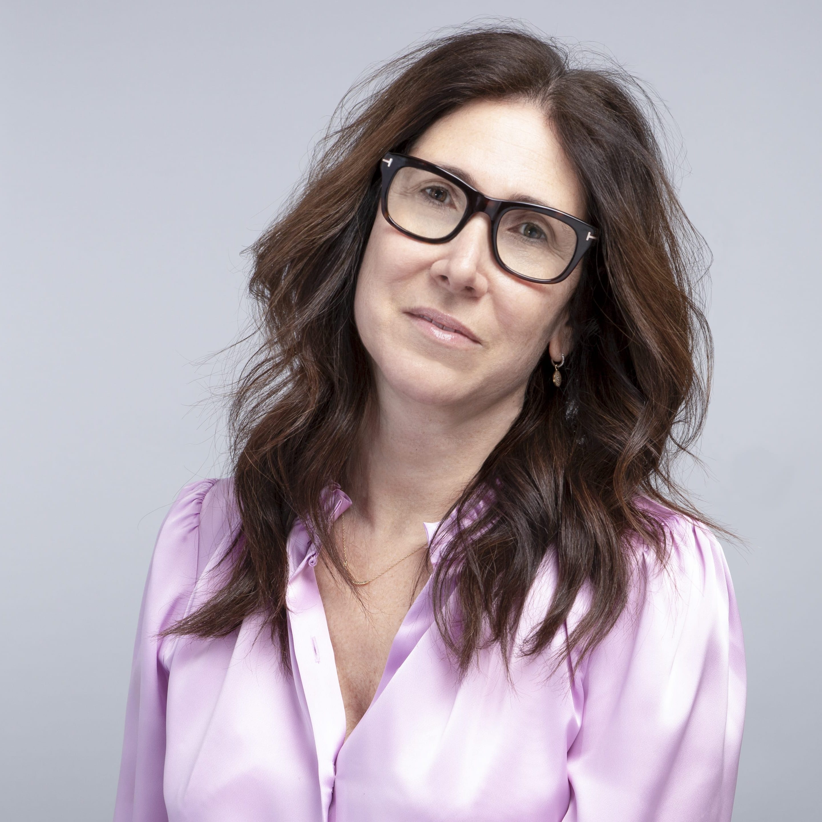 Amanda Lundberg wearing glasses and a lavender blouse