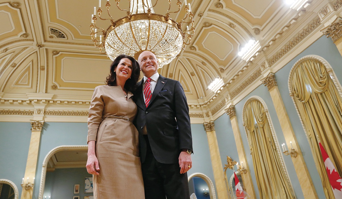 Vicki and Bruce Heyman together beneath a chandelier in a formal room