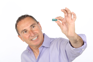 AmberSemi founder and CEO Thar Casey holding a small semiconductor device