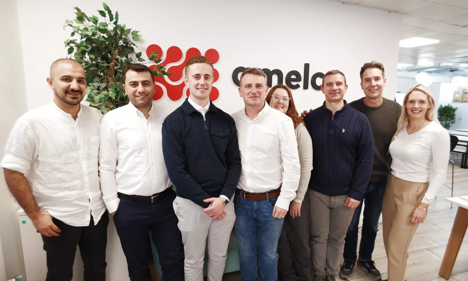 Members of the Amelco team gathered in an office
