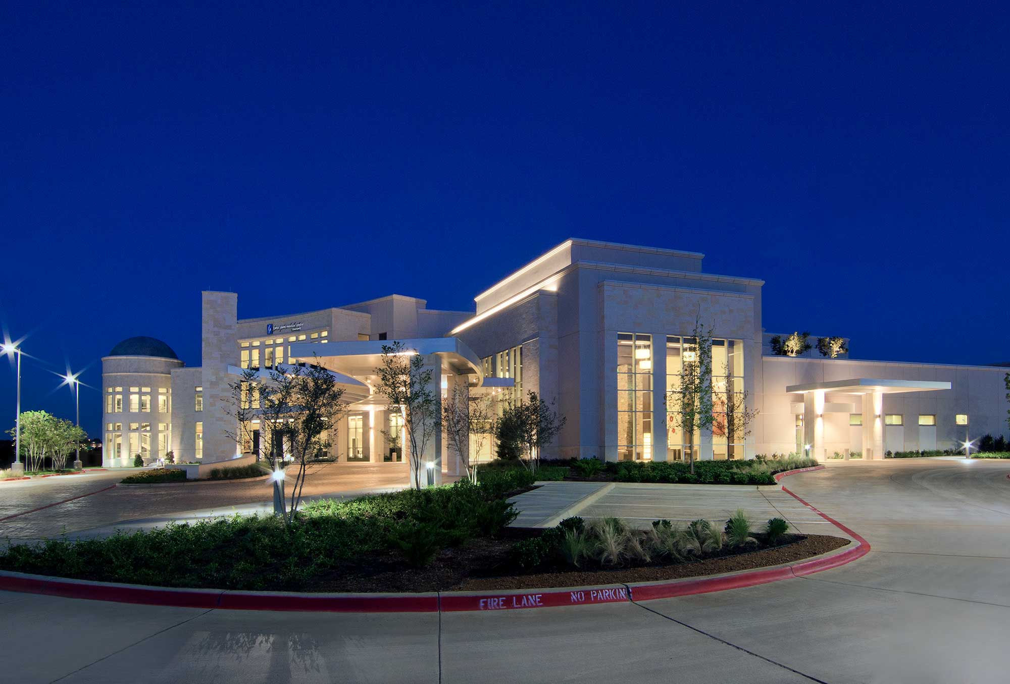 A healthcare property pictured on American Healthcare REIT’s website, illuminated at dusk