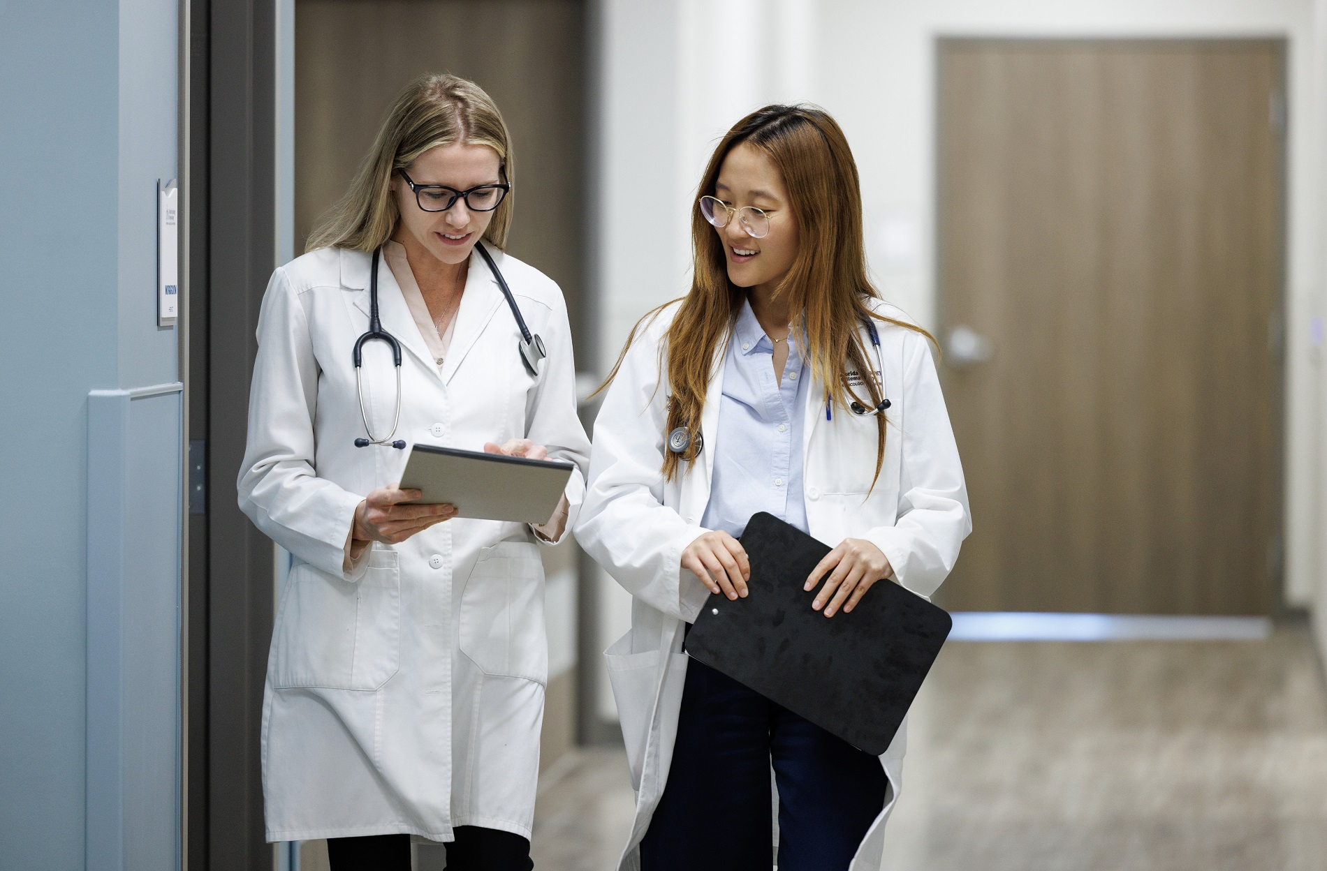 Clinicians walking through a Florida Oncology and Hematology practice corridor