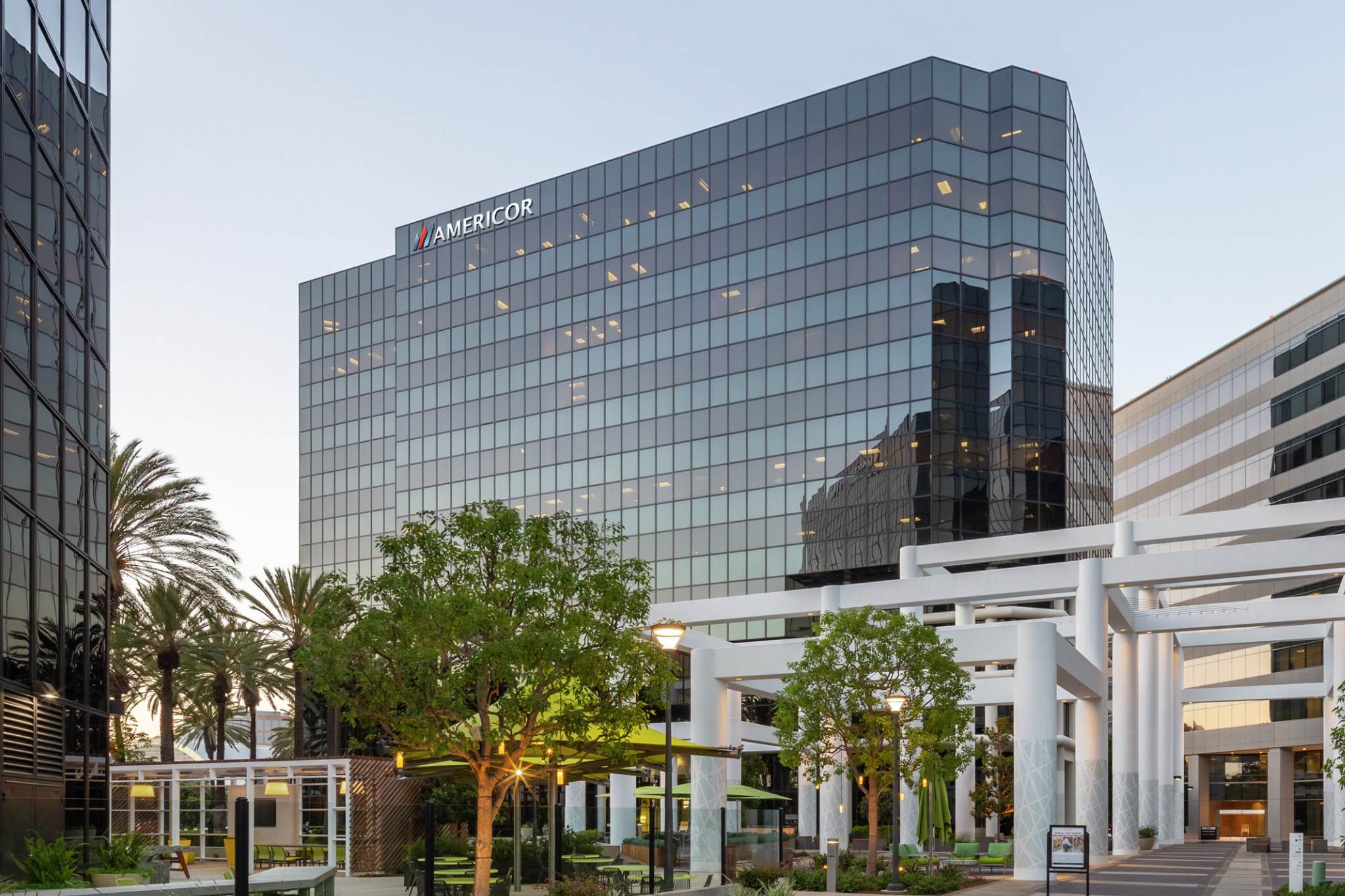 Americor sign on a glass office building, photographed from the courtyard