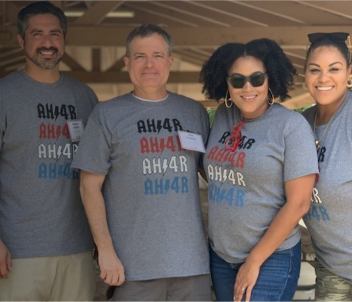 Four AMH team members wearing company shirts