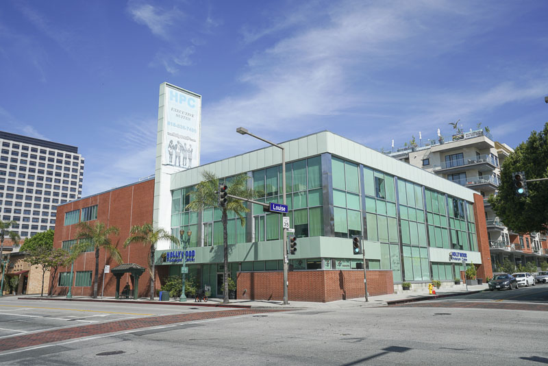 Glass-fronted Hollywood Production Center building at a street corner