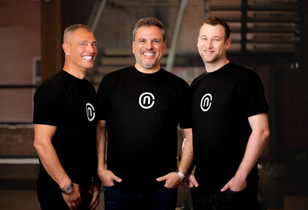 Erez Yarkoni, Zohar Alon and Amihai Neiderman standing together in NewCore shirts
