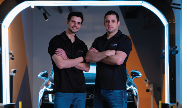 Amir and Ohad Hever standing by UVeye inspection equipment