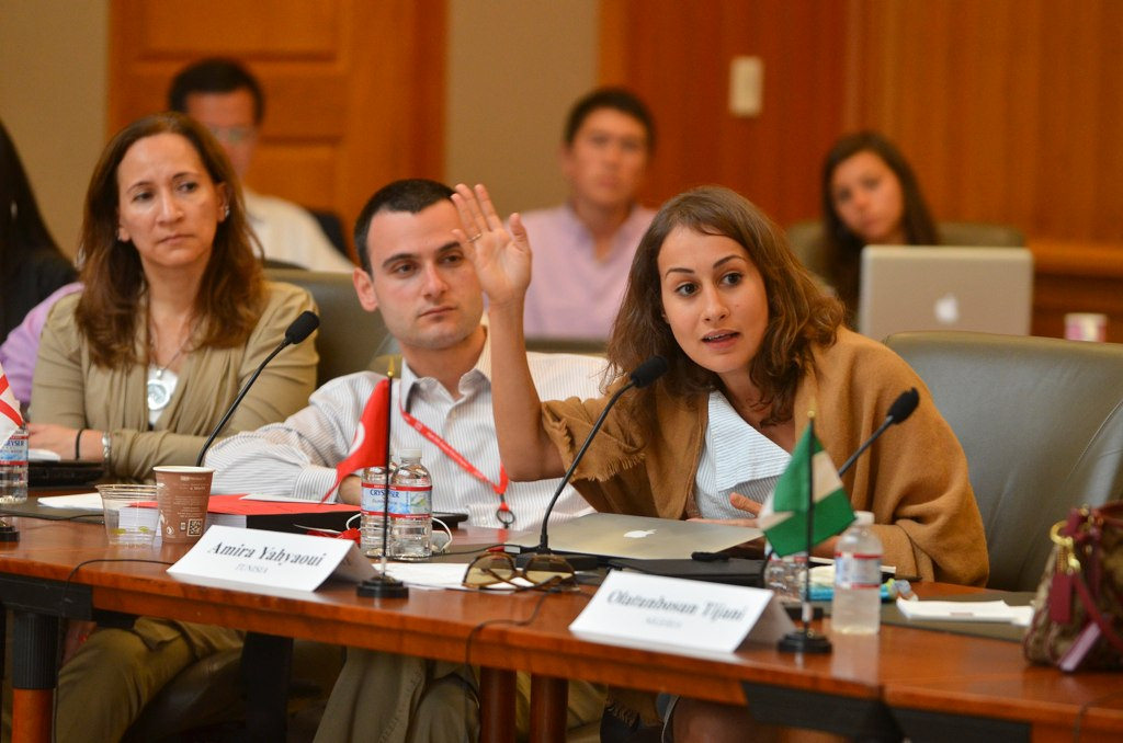 Amira Yahyaoui speaking at a conference table during Stanford’s 2014 Draper Hills Summer Fellowship