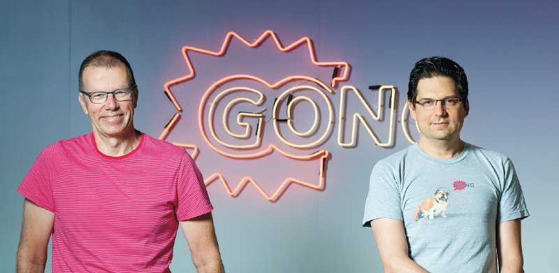 Amit Bendov and Eilon Reshef standing in front of a Gong sign