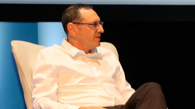 Amit Birman seated onstage at the July 2025 national economic conference