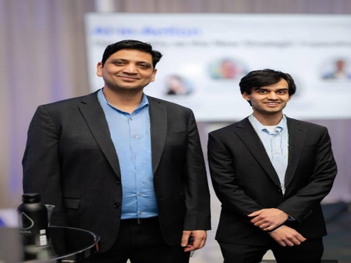 HiLabs co-founders Amit Garg and Neel Butala standing together at a company event