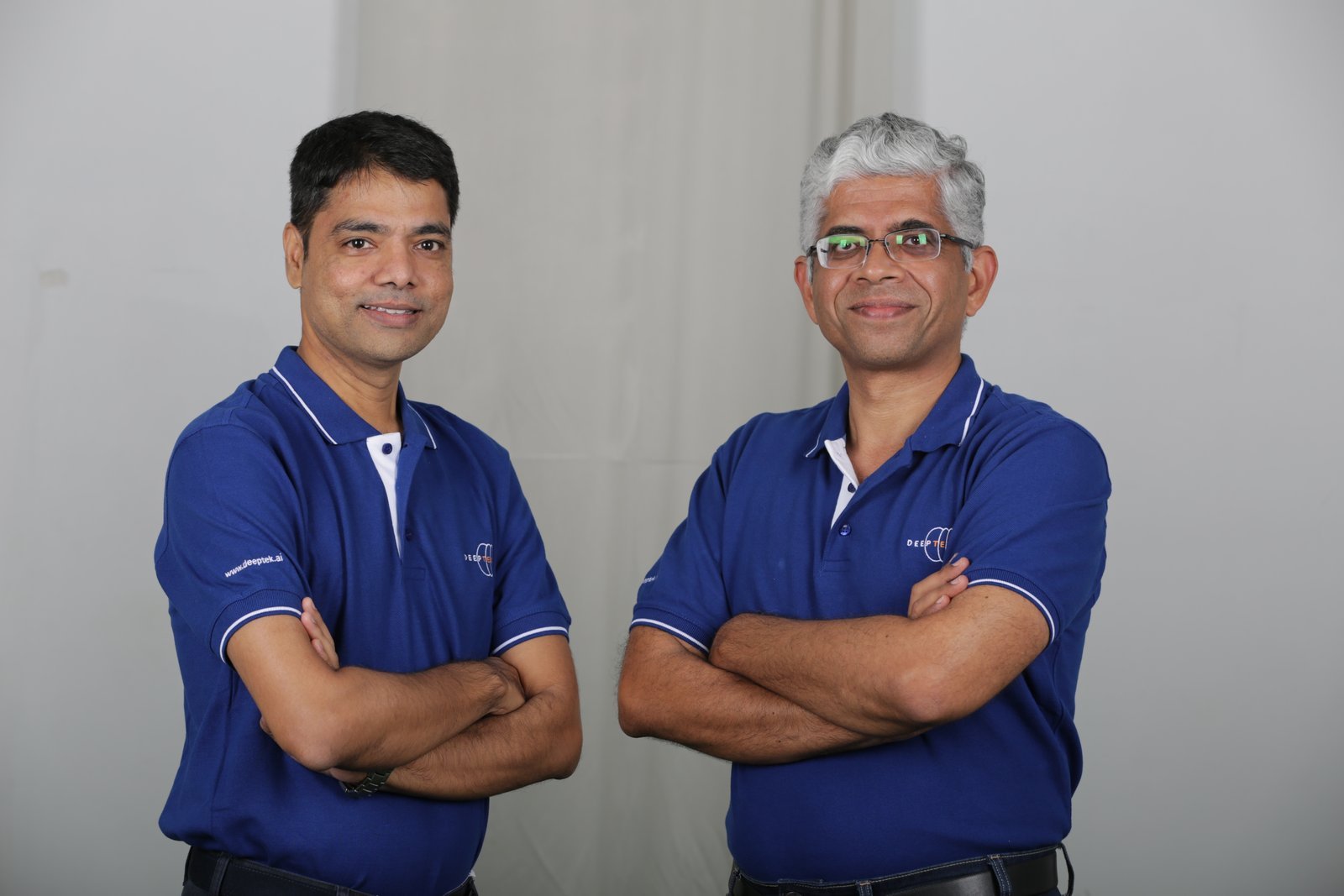 Dr. Amit Kharat, left, and DeepTek co-founder Ajit Patil, right, wearing blue company polo shirts