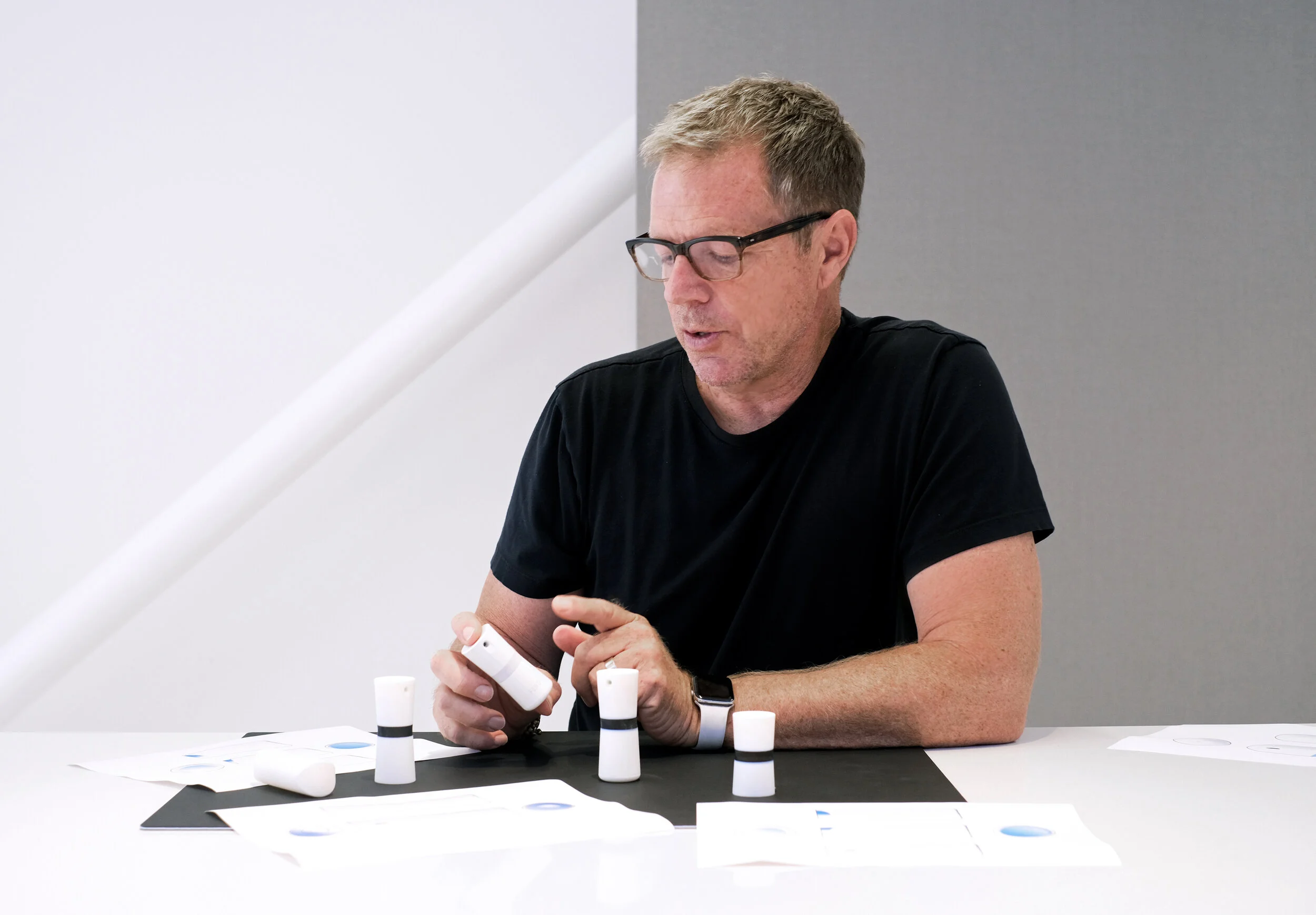 Robert Brunner at a table examining FEND device prototypes