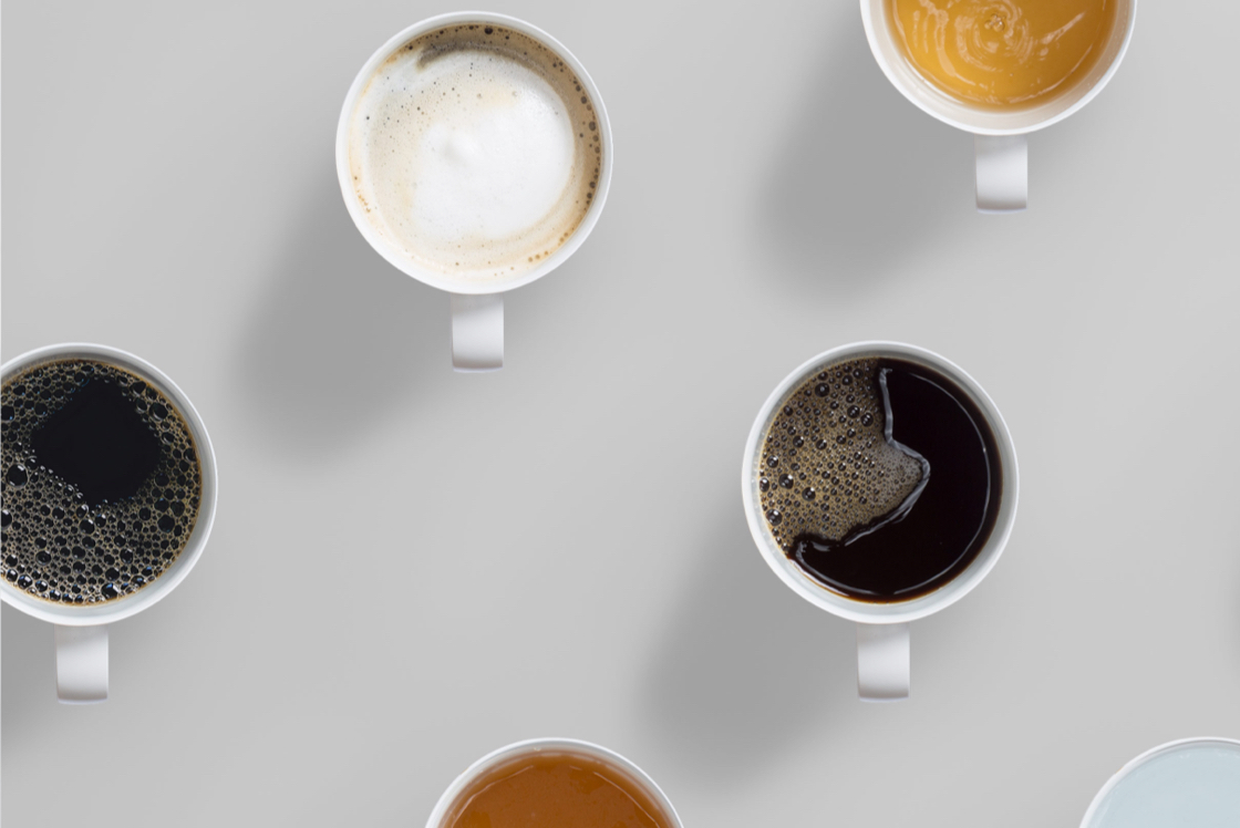 Ember ceramic mugs filled with coffee and tea, photographed from above