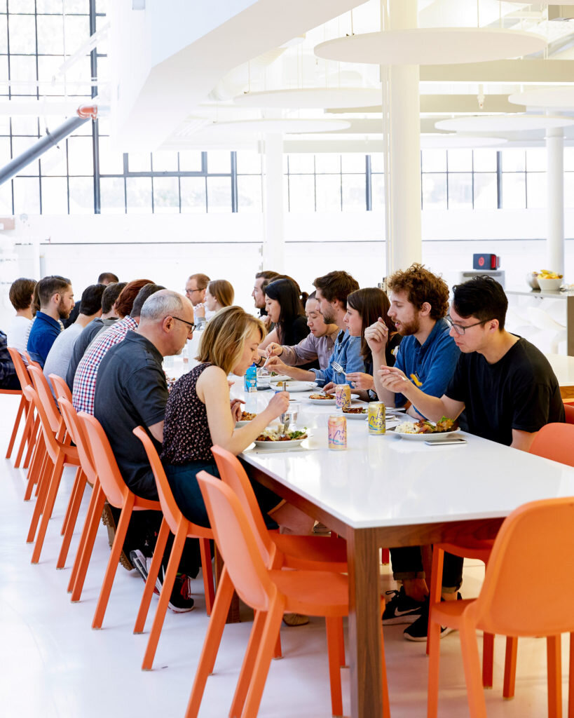 Ammunition staff sharing lunch at a long studio table