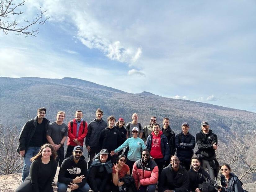Ampcontrol team posing together outdoors on a wooded hillside