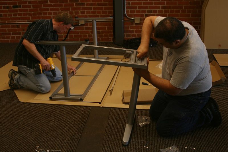 Mike Olson and Amr Awadallah assembling an upside-down desk in Cloudera’s first office