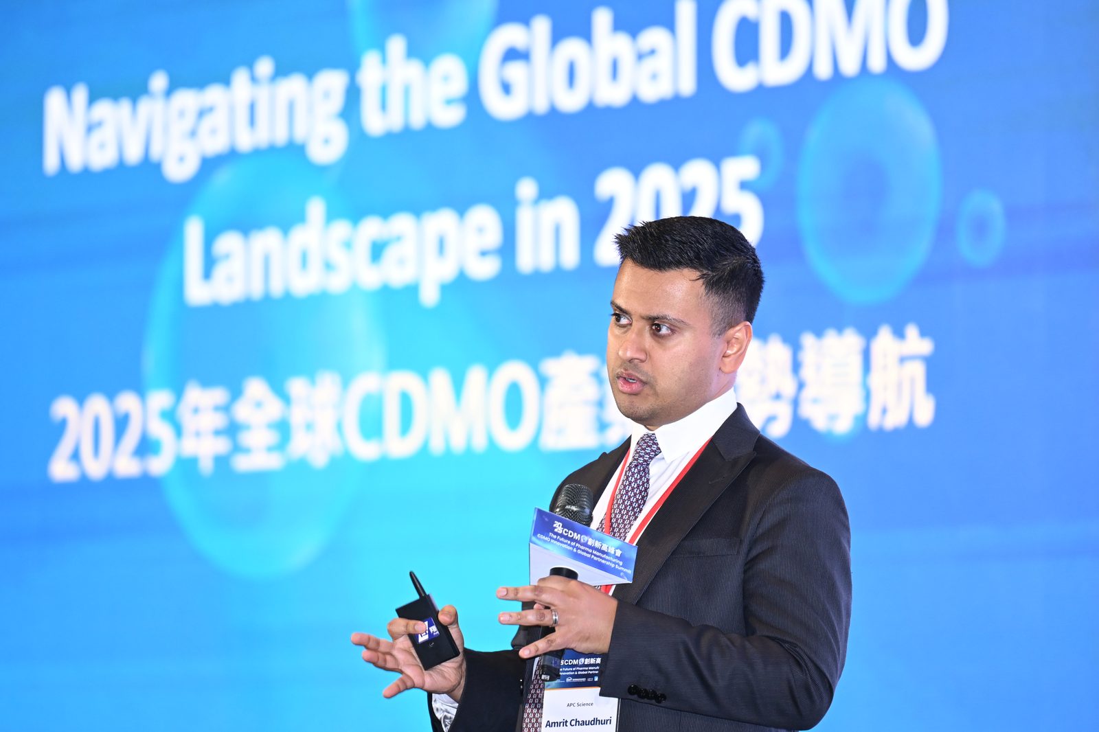 Amrit Chaudhuri speaking with a microphone at a Taiwan industry summit in 2025