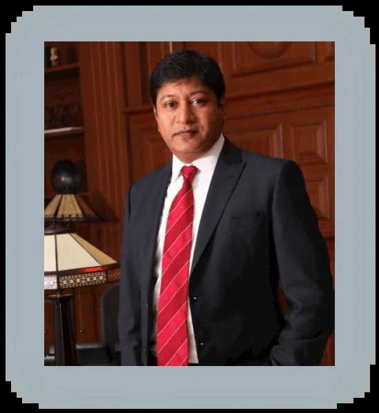Amtex founder Sunny Pokala wearing a dark suit and red tie