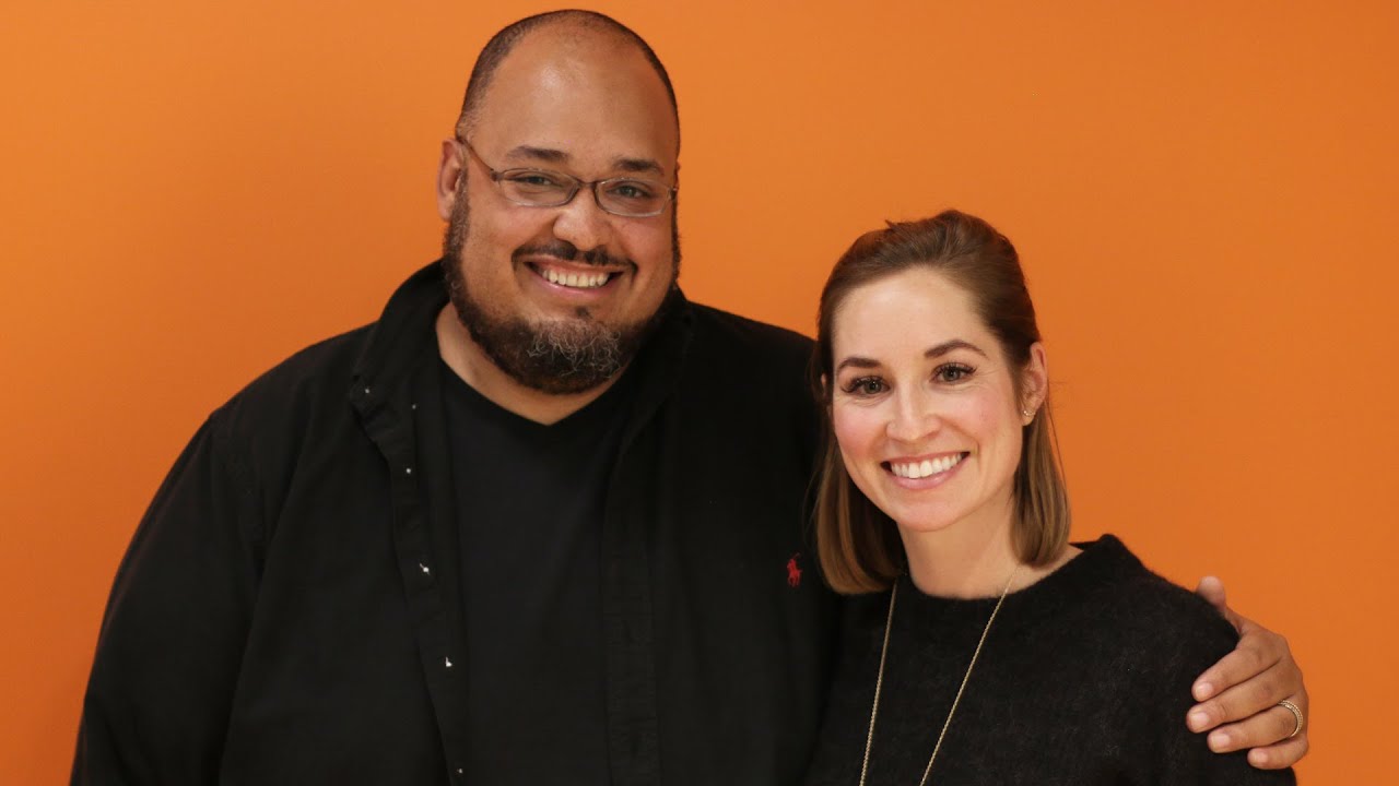 Amy Buechler with Michael Seibel in front of an orange backdrop