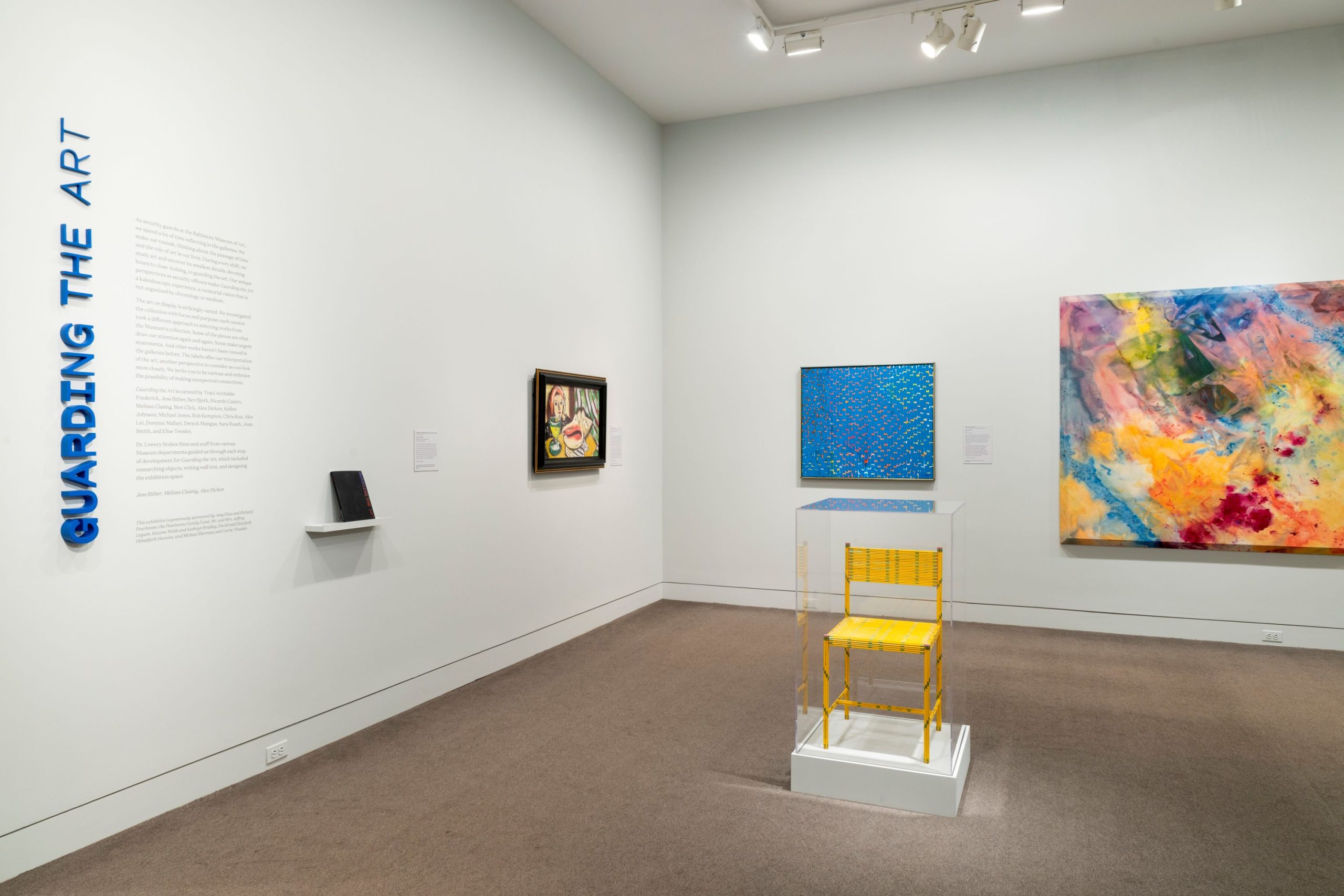 Guarding the Art installation at the Baltimore Museum of Art, including a yellow chair made from pencils inside a display case