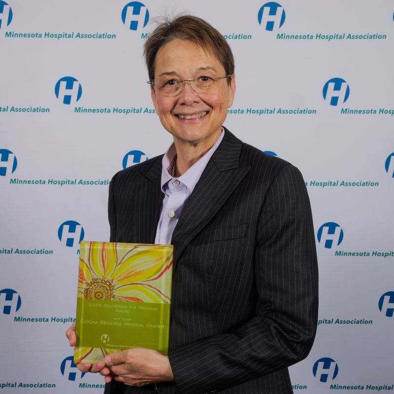 Amy Hart smiling while holding the 2025 Minnesota Hospital Association Delivering the Message award