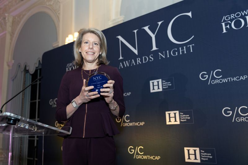Amy King holding an award at the 2025 Healthcare Technology Report event in New York