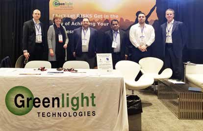 Greenlight Technologies representatives at a conference exhibition booth