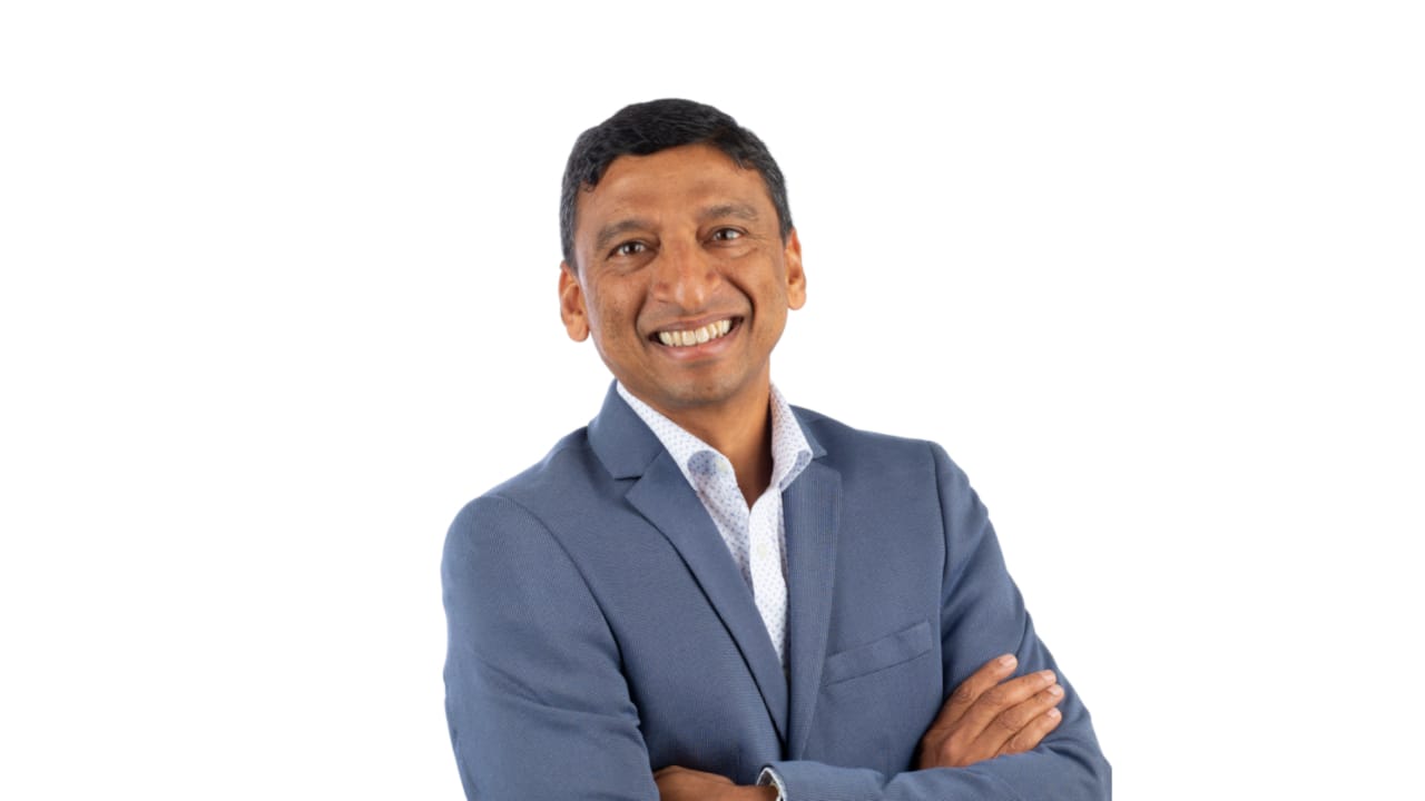 Anant Kale smiling in a blue suit