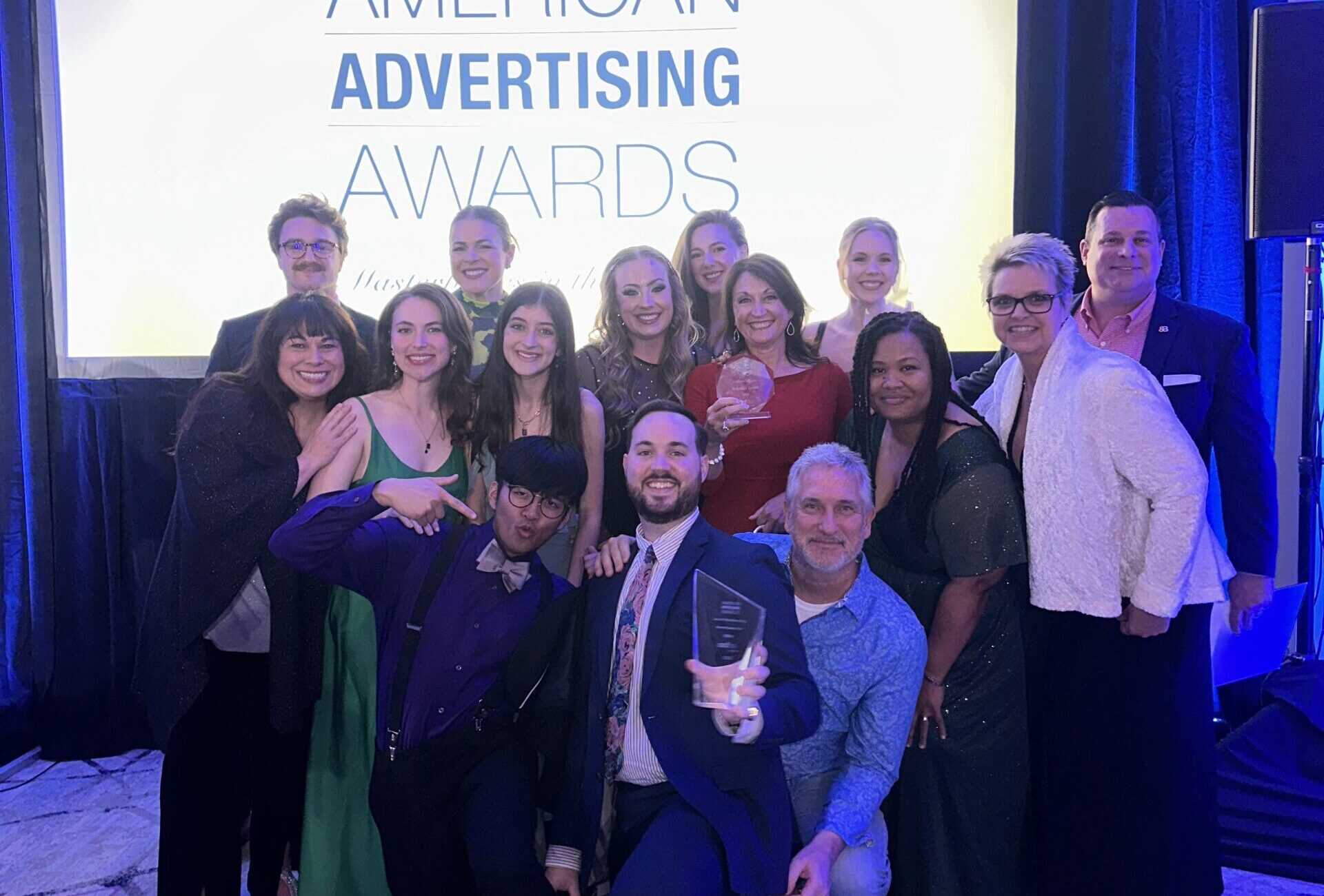 The &Barr team posing with trophies at the American Advertising Awards