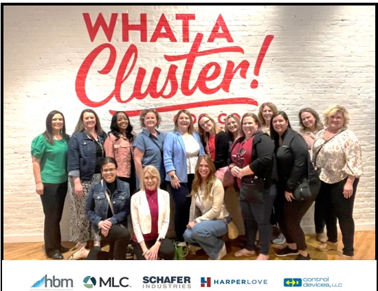 HBM portfolio HR summit participants gathered beneath a What a Cluster sign at the Goo Goo Cluster Factory in Nashville