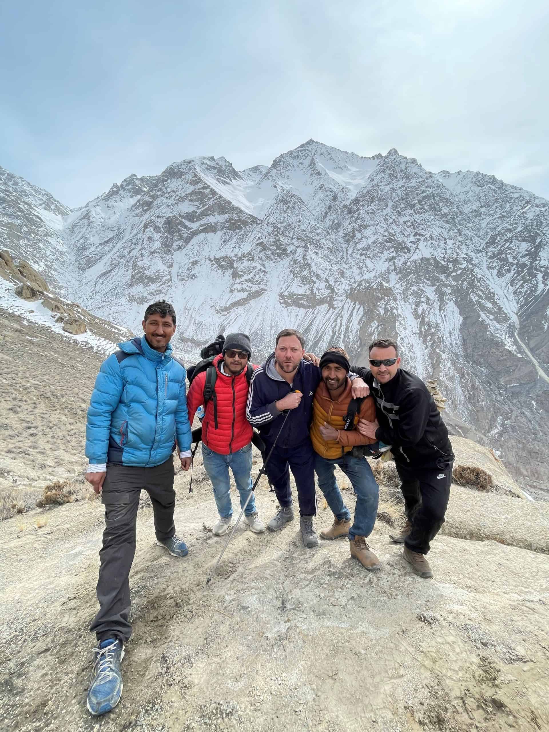 Andre Privateer, centre, standing with four companions beneath snow-covered mountains near Skardu