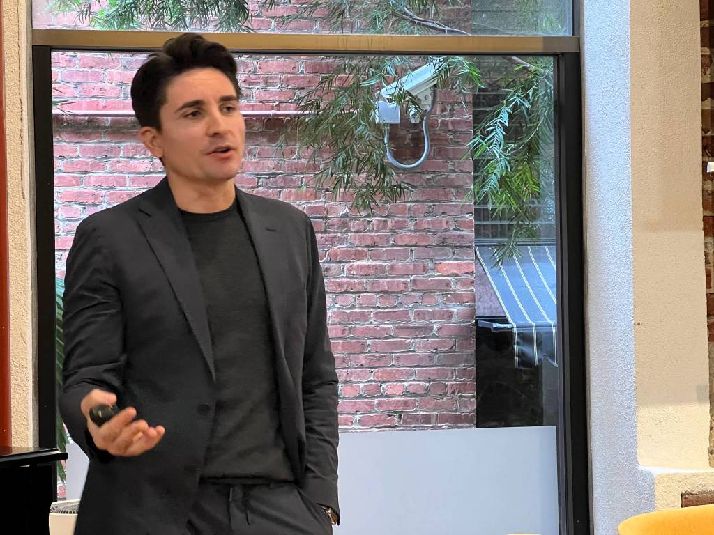 Andrea Carcano speaking with a presentation remote at Innovit in San Francisco