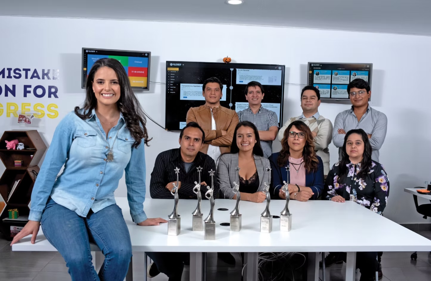 Andrea de Anda, at left, with Ojiva colleagues, awards and monitoring screens