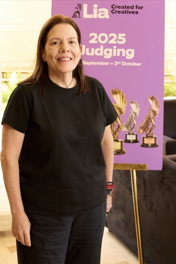 Andrea Diquez beside the London International Awards 2025 judging backdrop and trophies