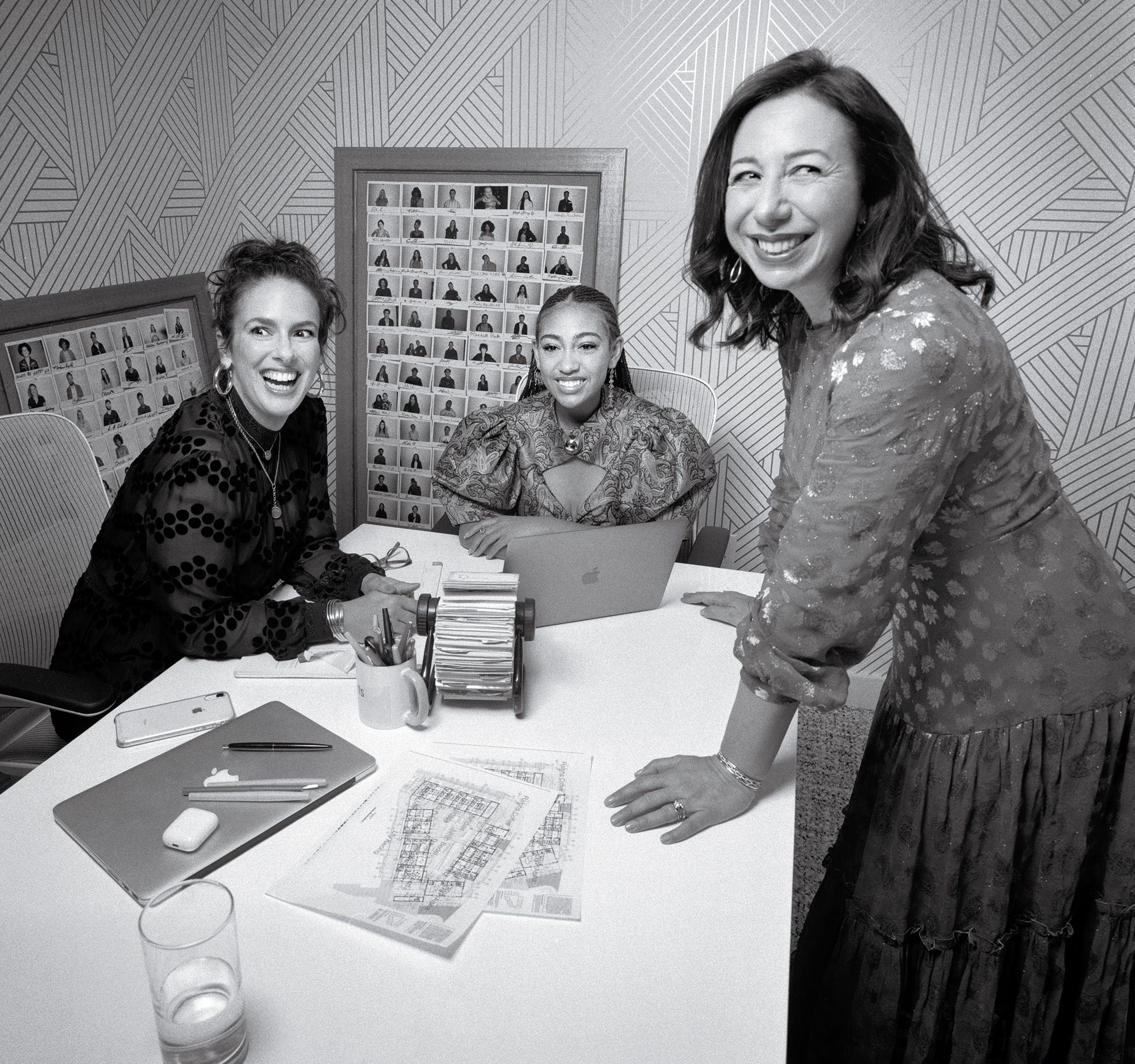 Nicole Vecchiarelli, Lexi Underwood and Andrea Oliveri smiling around a table in the Special Projects office