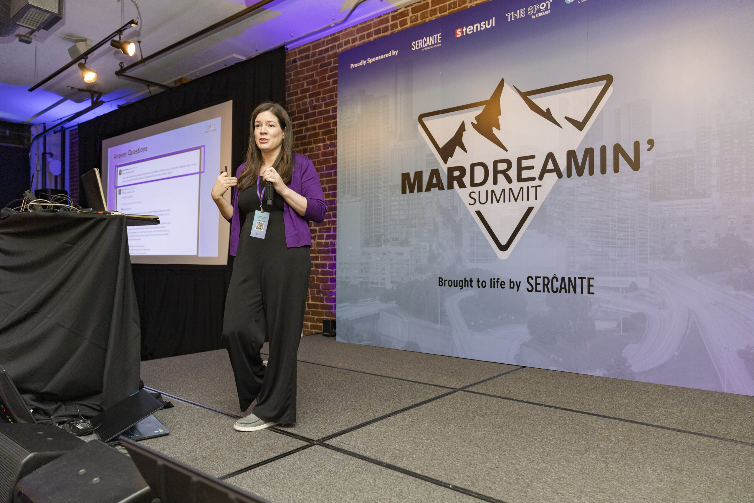 Andrea Tarrell speaking on stage at the MarDreamin' Summit in Atlanta