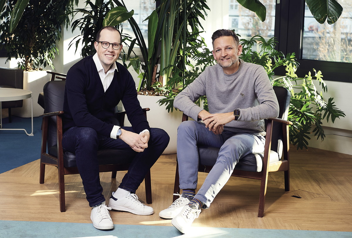 Marc Hauser, left, and Andreas Iten, right, seated together among plants