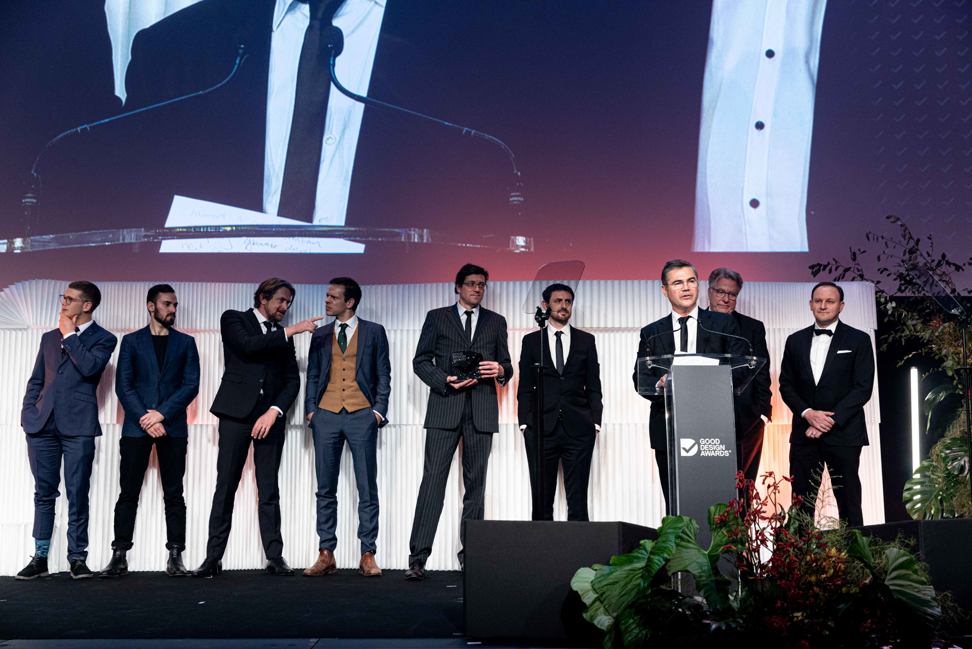 Andrew Adamovich speaking at the lectern with AdvanCell and Design + Industry colleagues at the 2022 Good Design Awards
