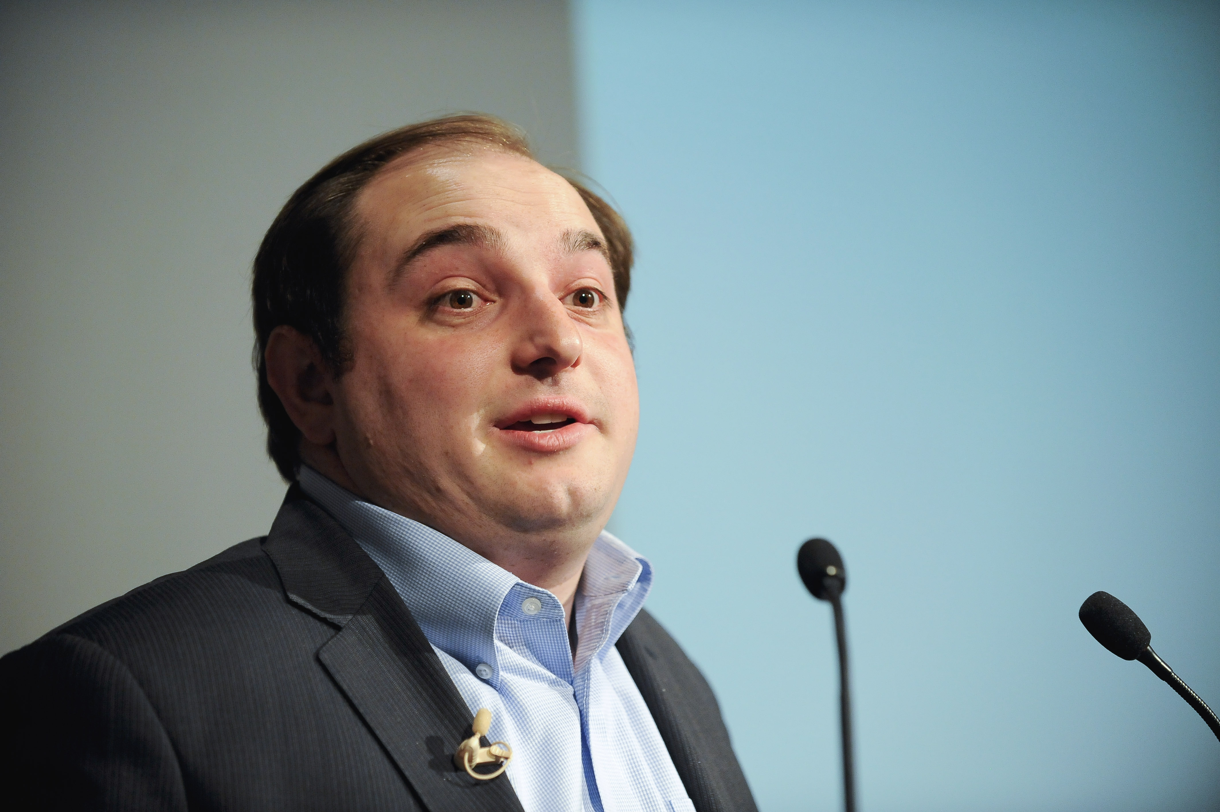 Andrew Bleeker speaking at microphones during the 2013 Kenneth Owler Smith Symposium at USC Annenberg