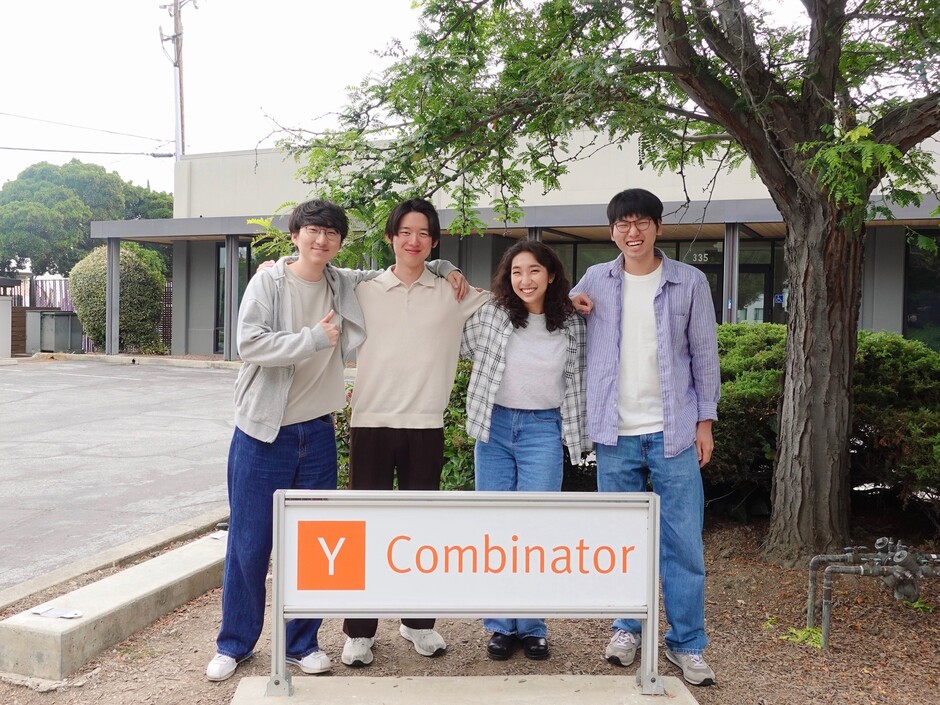 The Weavel team standing together behind a Y Combinator sign