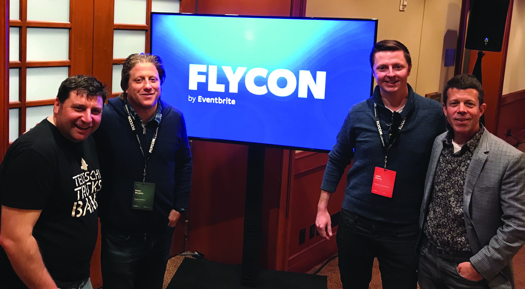 Dan Steinberg, Peter Shapiro, Luke Pierce and Andrew Dreskin standing together at FlyCon; Dreskin is at far right.